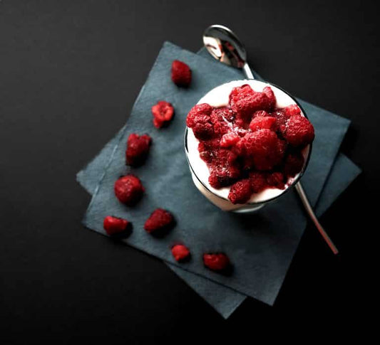 Yogurt with fresh raspberries representing probiotics as live bacteria for digestive health.